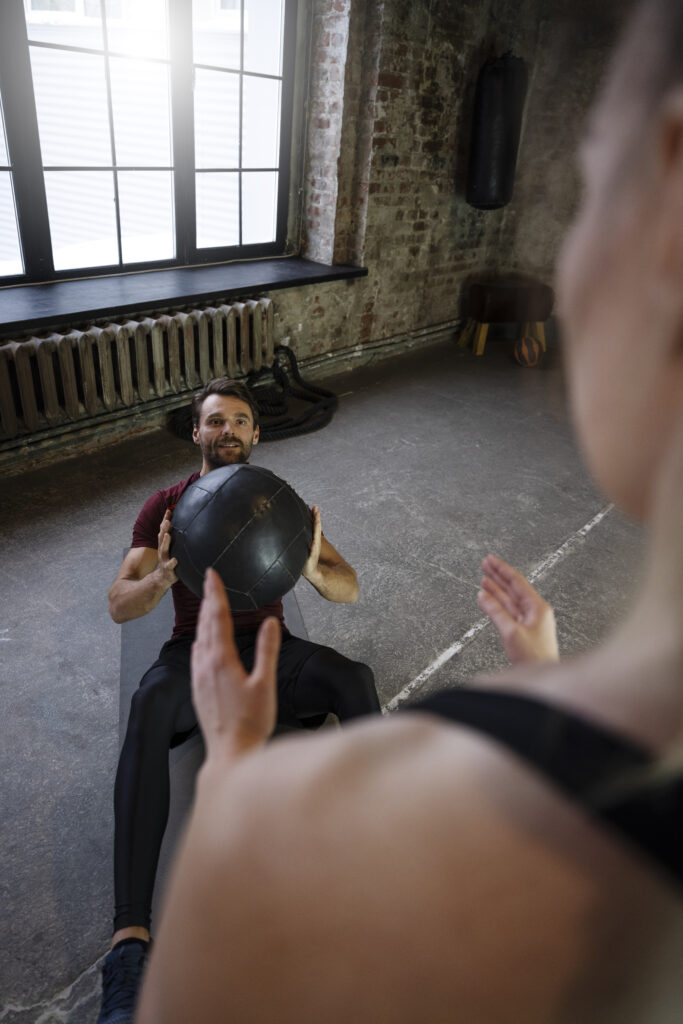 Athlete exercising with a heavy ball